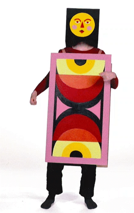 An illustrator dons a black square mask adorned with colorful circles and a rectangular costume showcasing geometric patterns, moving energetically in a motion designer's flair against a white background.